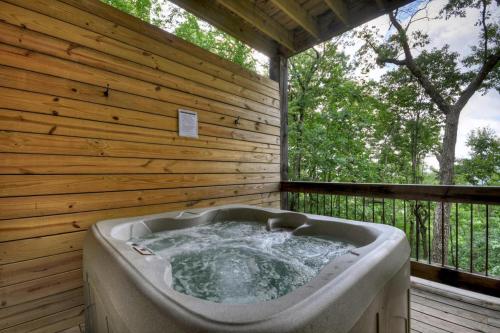 a large bath tub in a room with a wooden wall at Stardust Ridge in Northcutt