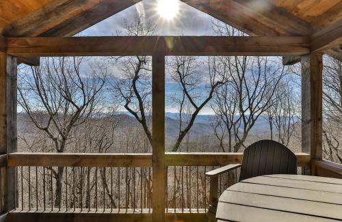 a table and chair on a screened in porch with a view at Stardust Ridge in Northcutt