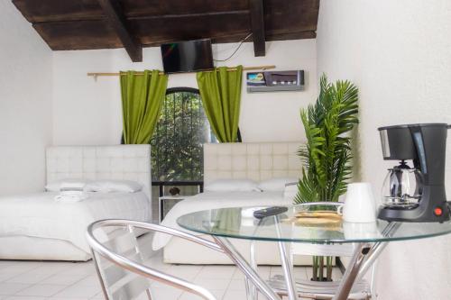 a dining room with a glass table and chairs at Hotel Casona del Valle in Potrerillos