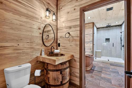 a wooden bathroom with a sink and a toilet at Stardust Ridge in Northcutt