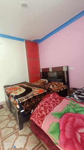 Postel nebo postele na pokoji v ubytování Global Home Stay