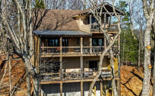 a large house with a deck in the woods at Stardust Ridge in Northcutt