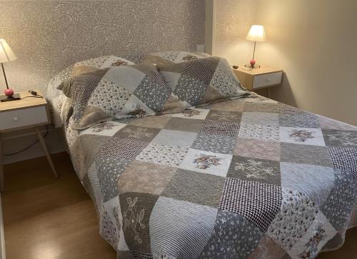 a bedroom with a bed with two night stands at Chez Bilhouet in Segonzac