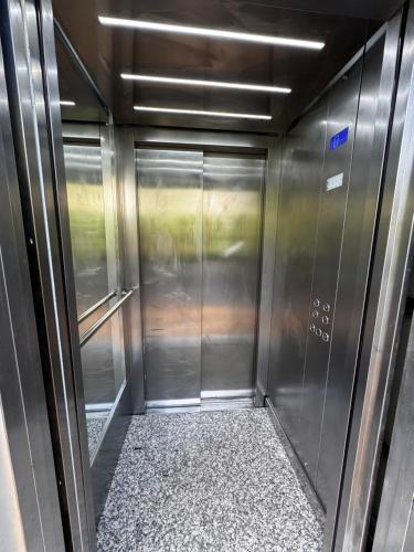 an empty elevator in a train with a corridor at Vila ZOGAJ in Ksamil