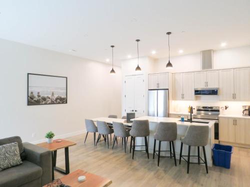 a kitchen and living room with a table and chairs at Beach Suites in Parksville