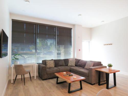 a living room with a couch and a table at Beach Suites in Parksville