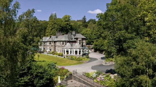 an aerial view of a large house with trees at Merewood Country House Hotel in Windermere