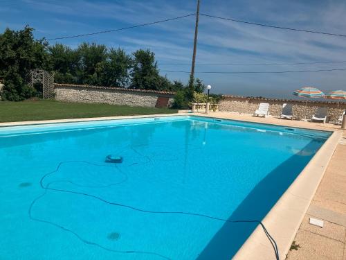 a blue swimming pool with a painting on it at Chez Bilhouet in Segonzac