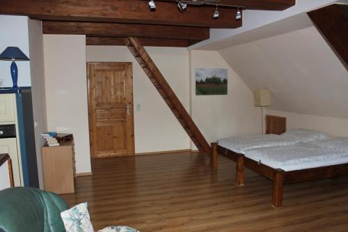 a living room with two beds and a wooden floor at Ferienwohnung Prenzlau in Prenzlau