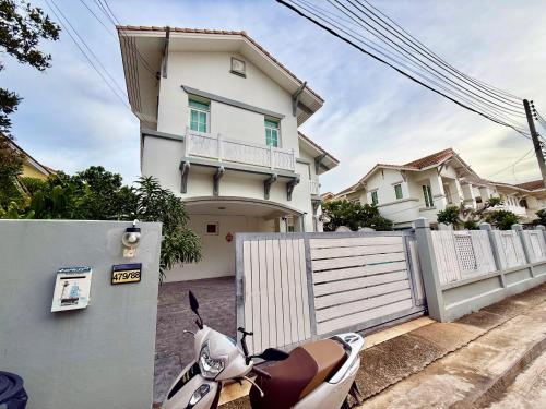 a motorcycle parked in front of a house at Warisa Garden Pool Villa in Jomtien Beach