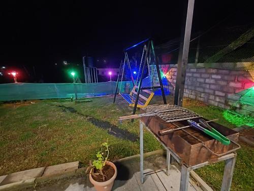 a grill in a yard at night with a playground at Mountain View Private Villa in Ooty