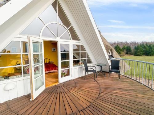 a deck with a view of a bedroom at Holiday Home Herlek - 450m from the sea by Interhome in Åkirkeby