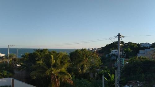 a view of a city with palm trees and the ocean at Casa para temporada Balneário de IRIRI Espírito Santo ES in Iriri