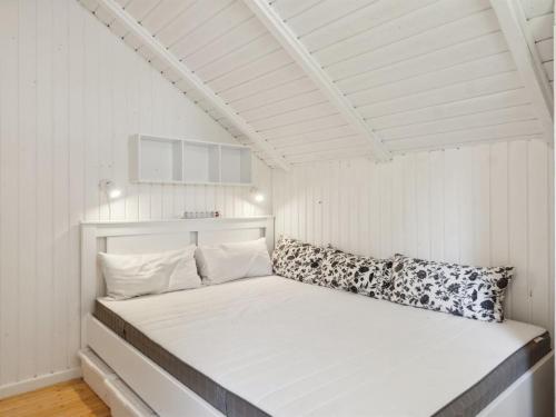 a white bed in a room with a white ceiling at Holiday Home Lennart - 4km from the sea by Interhome in Eskebjerg