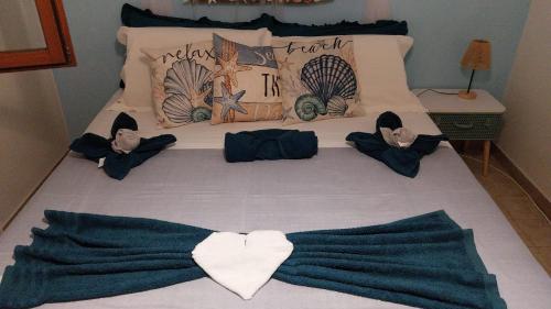 a bed with a bunch of blankets on it at Villa Ornella in Luni