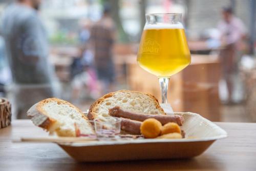a plate of food with a glass of beer and bread at Hotel K2 in Sauze dʼOulx