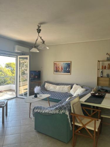 a living room with a couch and a table at Mikro Amoni Beach Villa in Pefkali