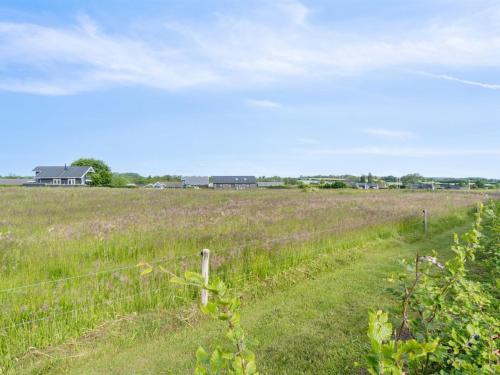 a fence in the middle of a field at Holiday Home Fentje - 200m from the sea by Interhome in Frørup