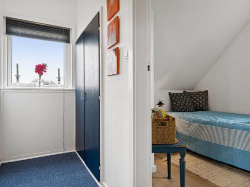a bedroom with a bed and a door with a window at Holiday Home Fentje - 200m from the sea by Interhome in Frørup