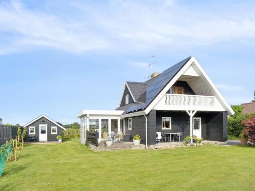a gray house with a black roof on a yard at Holiday Home Fentje - 200m from the sea by Interhome in Frørup