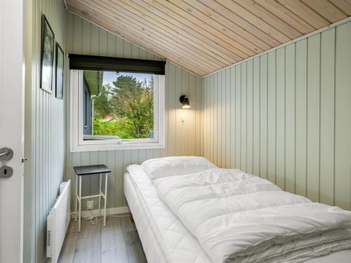 a bed in a room with a window at Holiday Home Alkil - 350m to the fjord by Interhome in Storvorde