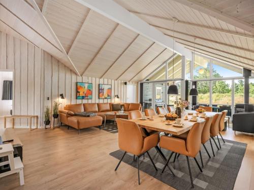 a dining room and living room with a table and chairs at Holiday Home Jeldrik - 1-5km from the sea by Interhome in Blåvand