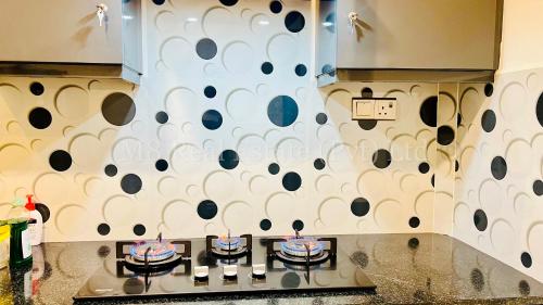 a kitchen with a wall with black and white dots at Beachfront Colombo 03 Bed Apartment in Colombo