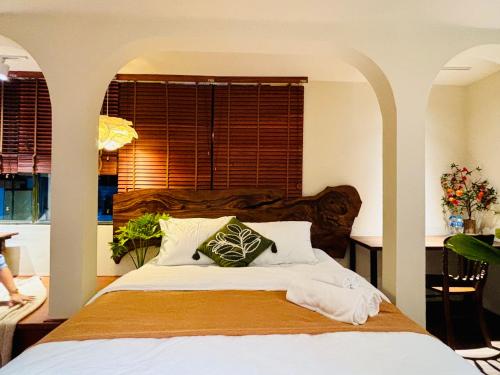 a bedroom with a large bed and a window at PINhome in Ho Chi Minh City