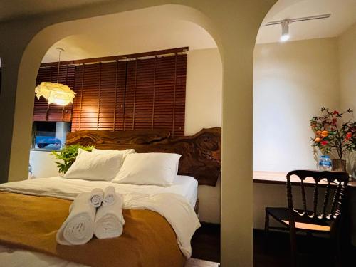 a bedroom with a bed with two towels on it at PINhome in Ho Chi Minh City