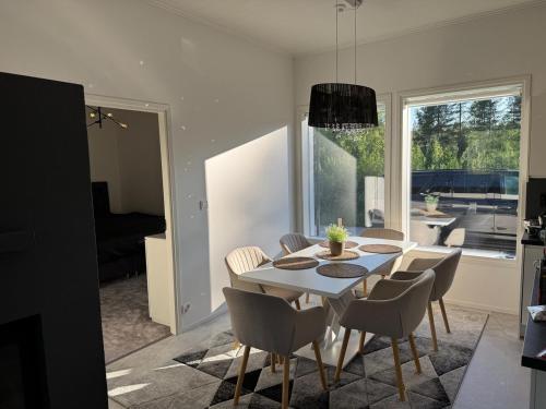 a dining room with a table and chairs at VillaSafe in Jyväskylä