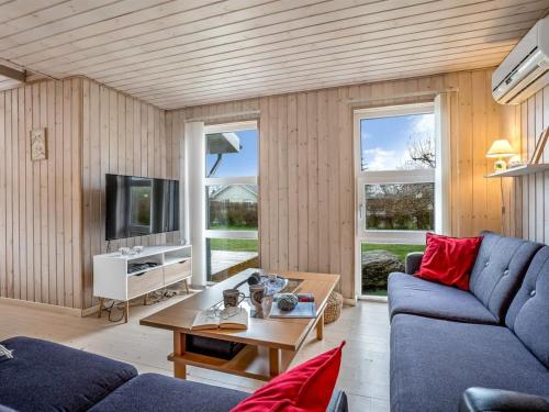 a living room with a blue couch and a table at Holiday Home Mira - 500m from the sea by Interhome in Gedser