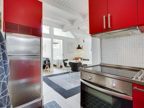 a kitchen with red cabinets and a counter top at Holiday Home Solfrid - 150m from the sea by Interhome in Esbjerg