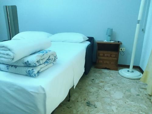 a bedroom with two beds with white sheets and a lamp at LZ SmartStays in Milan