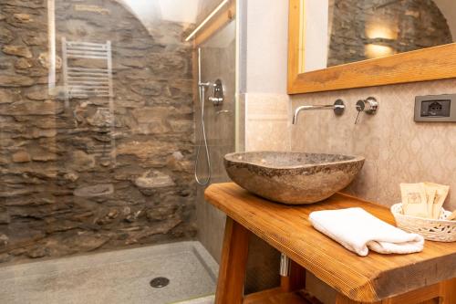 a bathroom with a stone shower and a sink at Hotel K2 in Sauze dʼOulx