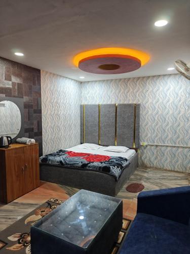 a bedroom with a large bed and a large ceiling at Hotel Parinay Vatika - Deoghar in Deoghar