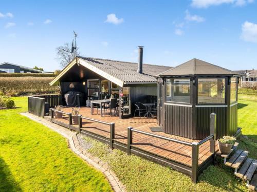 a house with a deck and a gazebo at Holiday Home Ofrath - 350m to the fjord by Interhome in Roslev