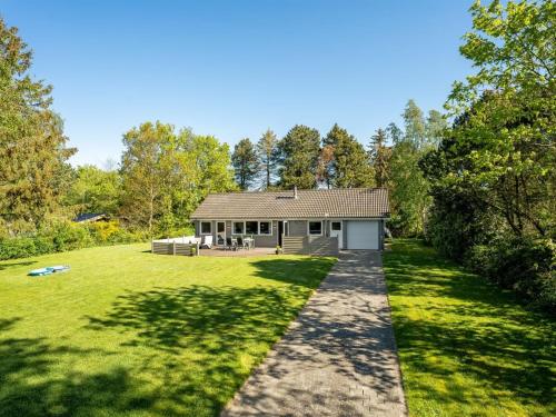 a home with a large yard with a house at Holiday Home Rohan - 700m from the sea by Interhome in Rødby