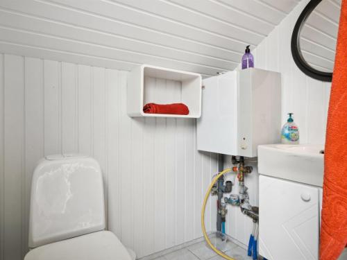 a bathroom with a toilet and a sink at Holiday Home Fenna - 30km from the sea by Interhome in Toftlund