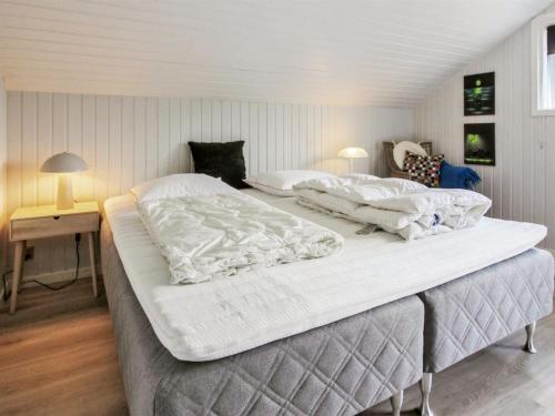 two large beds in a room with two lamps at Holiday Home Fenna - 30km from the sea by Interhome in Toftlund