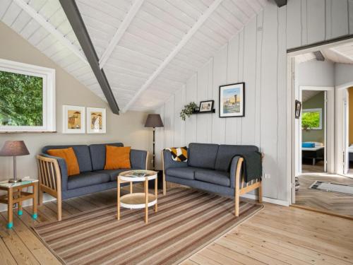 a living room with two blue couches and a table at Holiday Home Fenna - 30km from the sea by Interhome in Toftlund