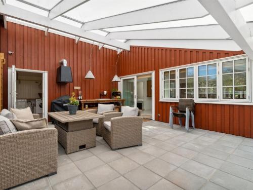 a patio with wicker chairs and a table at Holiday Home Tarje - 320m from the sea by Interhome in Rønne