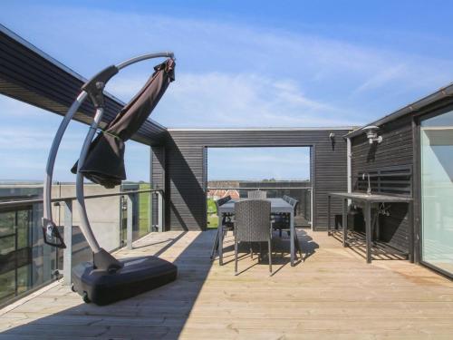 a balcony with a table and a metal apparatus at Holiday Home Stefani - 2km from the sea by Interhome in Havneby