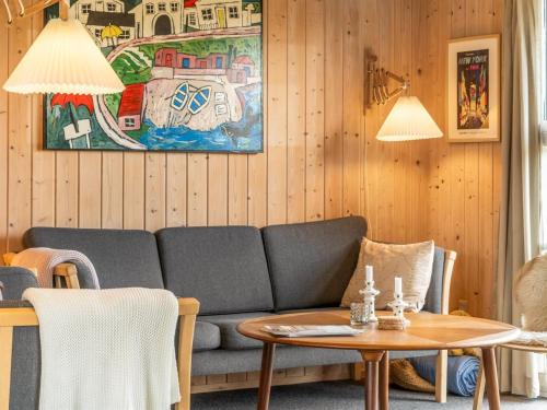 a living room with a couch and a table at Holiday Home Elisenda - 1km from the sea by Interhome in Torsted