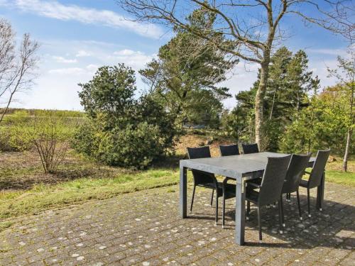a table and chairs sitting on a patio at Holiday Home Alina - 1km from the sea by Interhome in Mølby