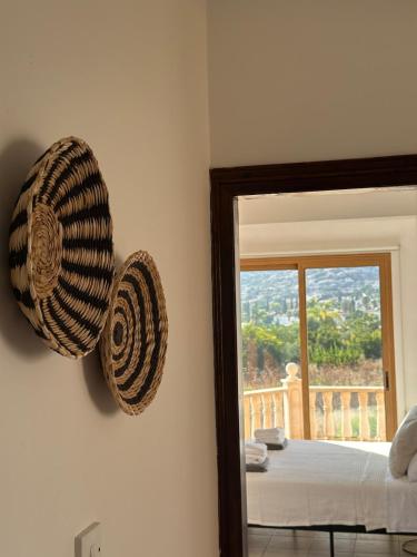 a mirror in a room with a bed and a window at Stay and Nest Casa Alba Modern Boho Villa with private Pool near to Sea, Paphos in Peyia