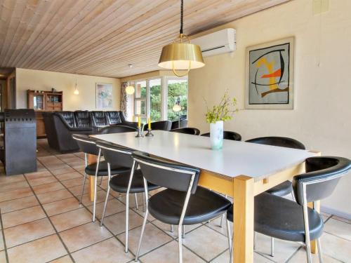 a dining room with a table and chairs at Holiday Home Alina - 1km from the sea by Interhome in Mølby