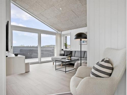 a living room with a couch and a table at Holiday Home Frithbjorn - 900m from the sea by Interhome in Jerup
