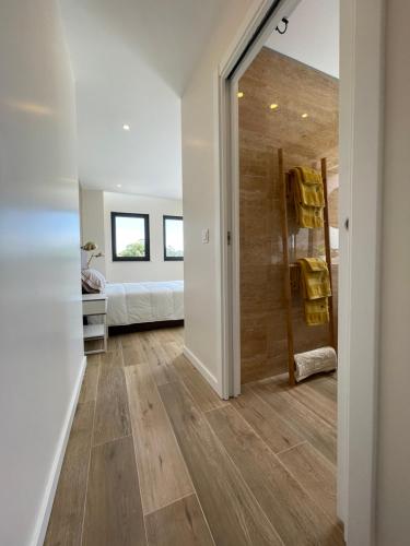 a bathroom with a walk in shower next to a bedroom at Living Viana do Castelo in Viana do Castelo