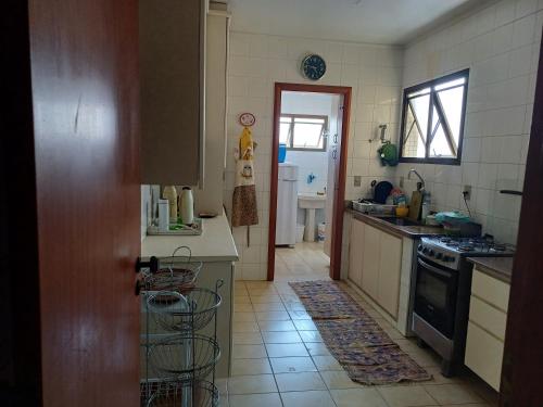 a kitchen with a sink and a stove at ApUbatuba in Ubatuba