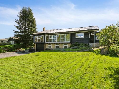 a house with a large lawn in front of it at Holiday Home Sölvy - 300m from the sea by Interhome in Børkop